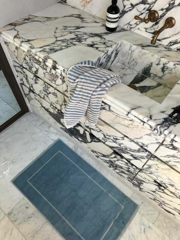 The bath mat folded to show both finished faces