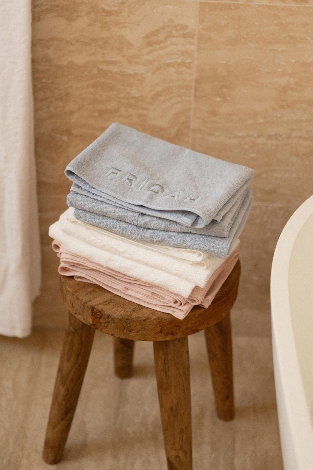 Three folded Barrier Towels in Cloud, Blush and Mist