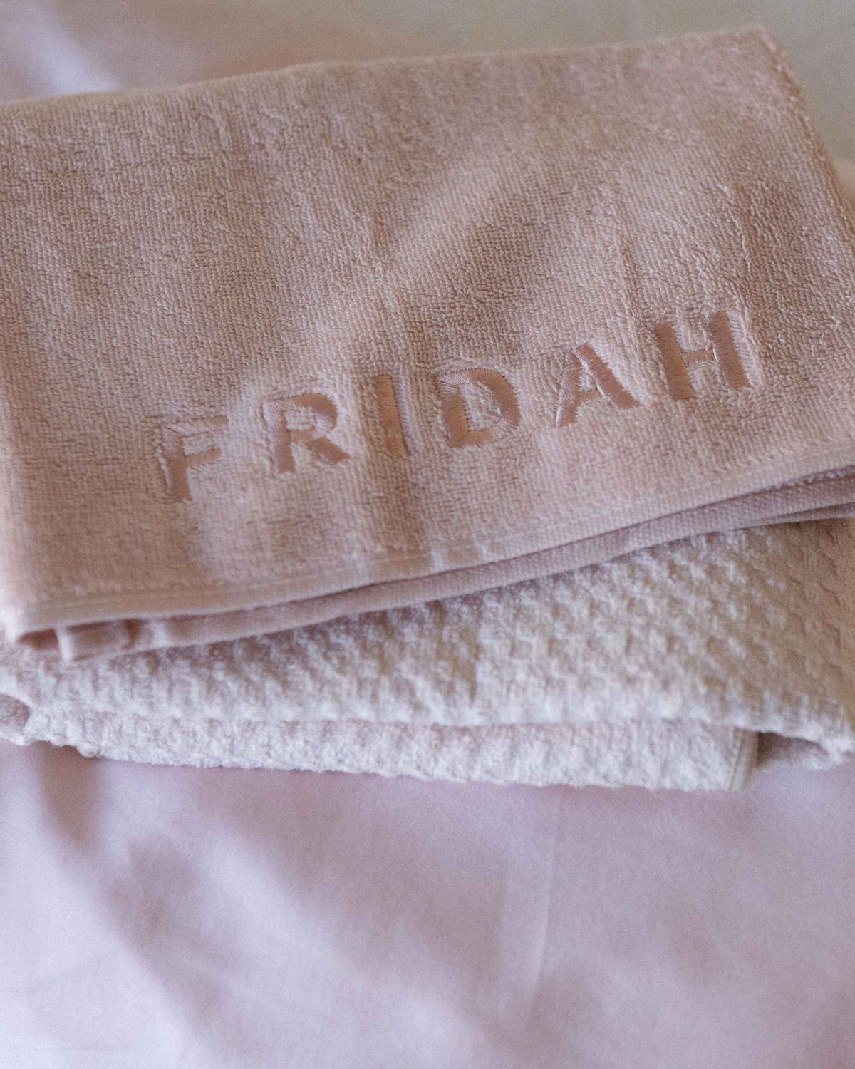 Blush | The Recovery System folded together, embossed Fridah logo on the towel