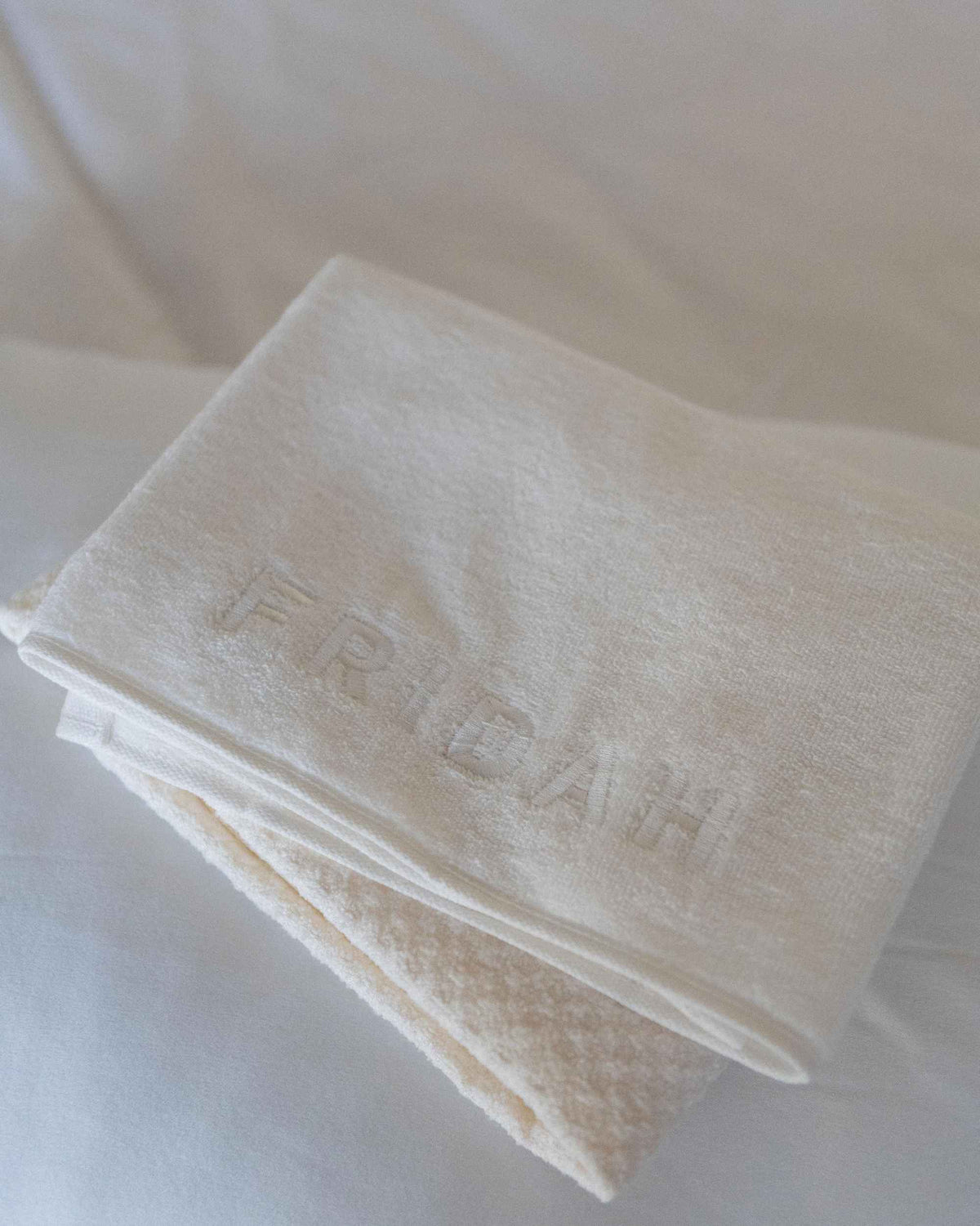 The Recovery System folded together, embossed Fridah logo on the towel