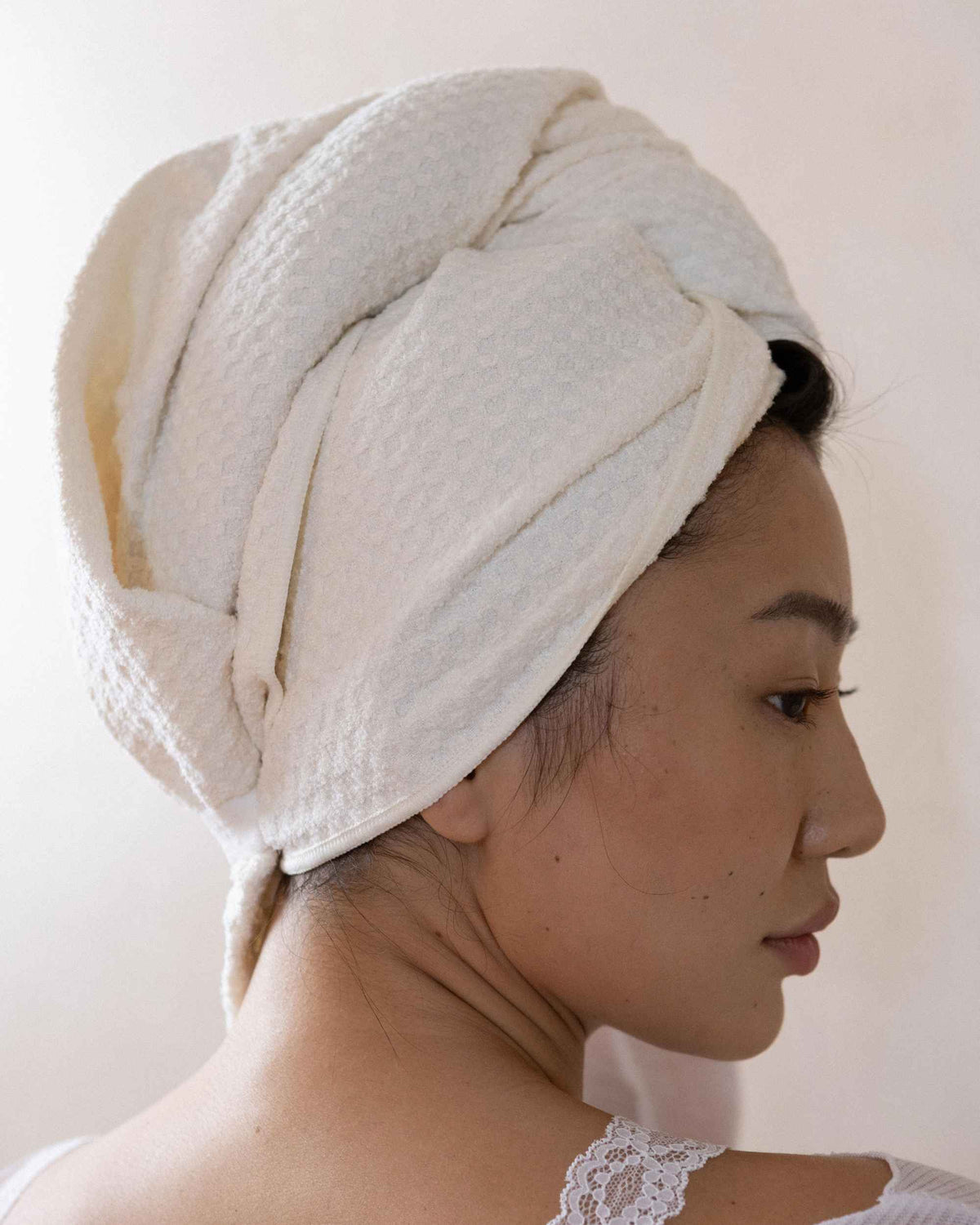The Repair Wrap on damp hair, looking over one shoulder