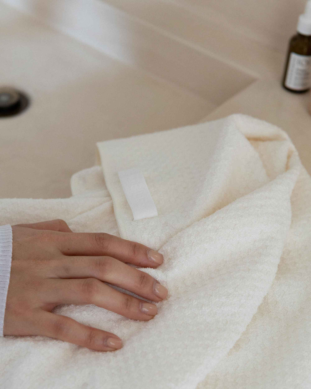 A hand on the folded Repair Wrap, showing the waffle texture and loop