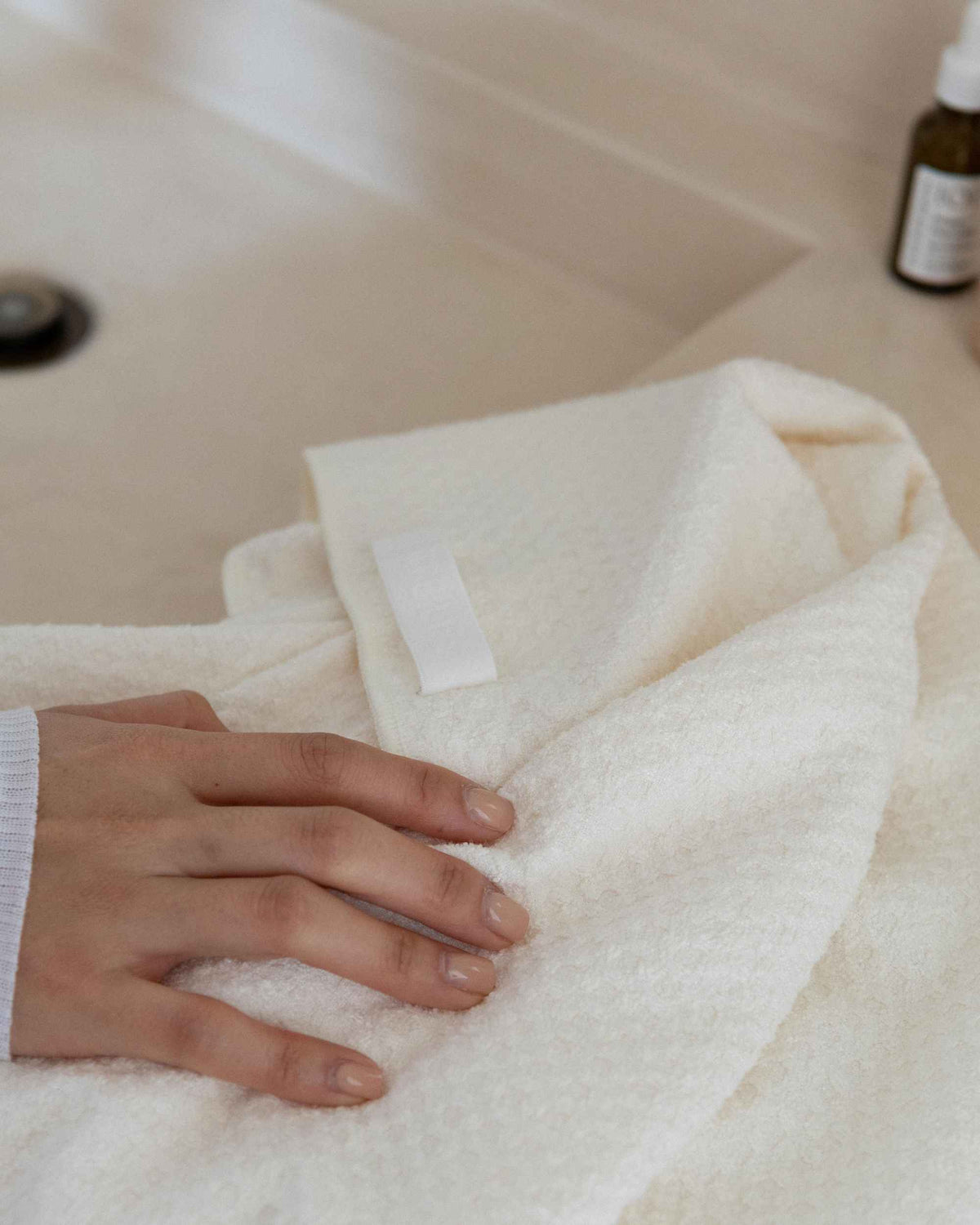 A hand on the folded Repair Wrap, showing the waffle texture and loop