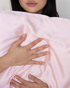 Blush | Hands resting on The Restore Case silk pillowcase