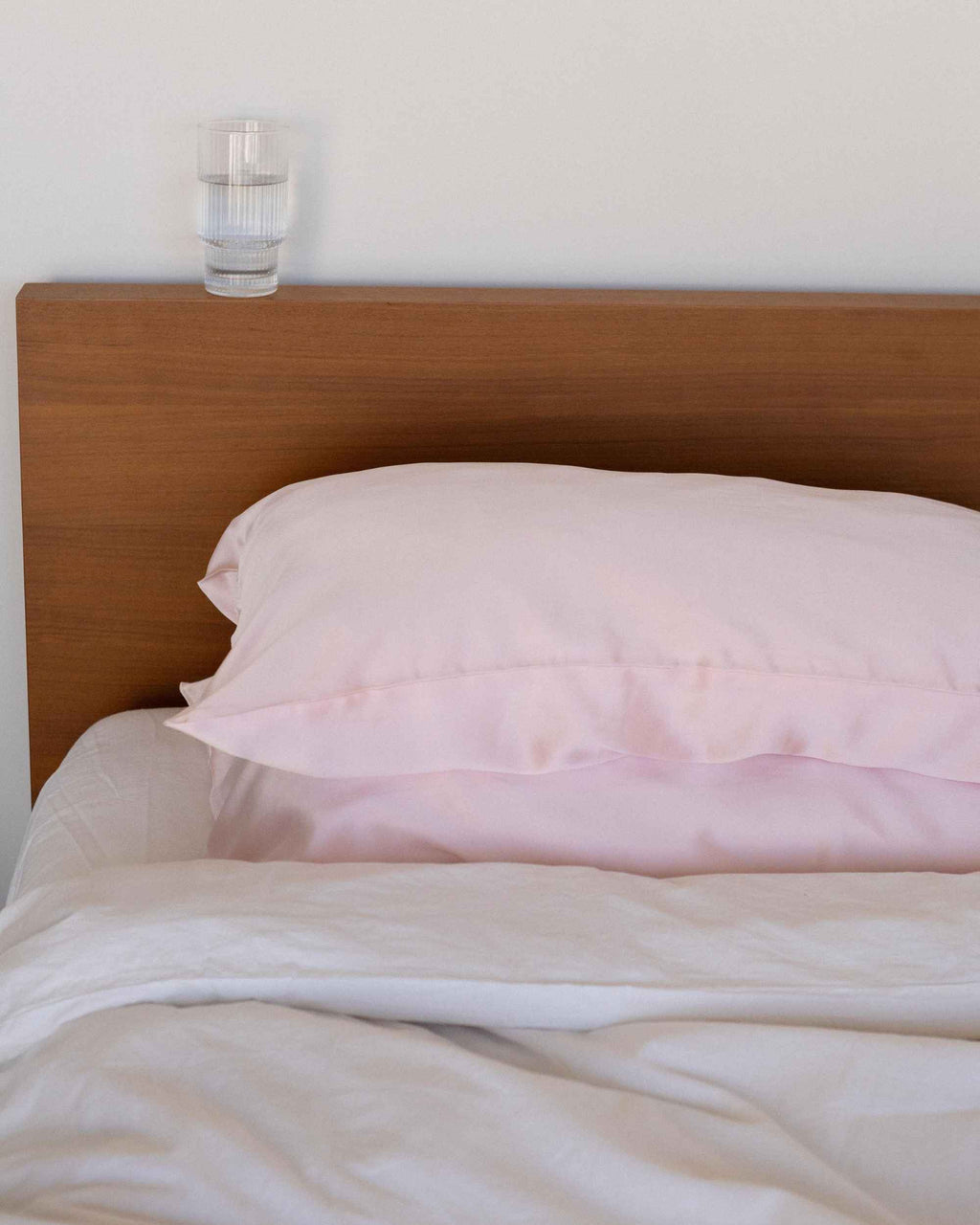 The Restore Case on a made bed, seen from the side