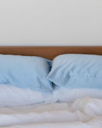 Mist | Two pillows in The Restore Case against a timber headboard