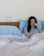 Mist | Sitting up in bed with The Restore Case behind
