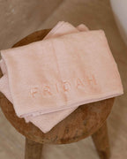 Blush | The Barrier Towel folded on stool