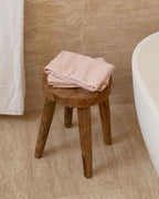 Blush | The Barrier Towel folded on a stool