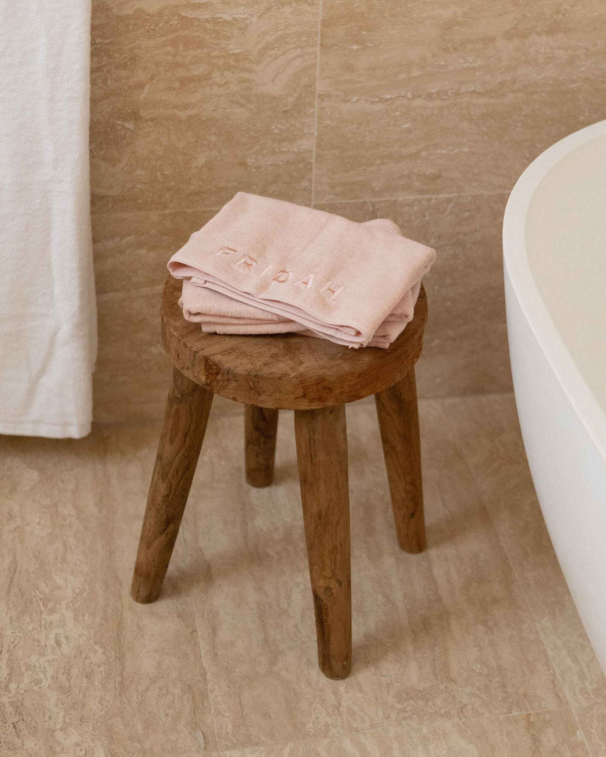 The Barrier Towel folded on a stool
