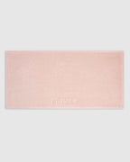 Blush | The Barrier Towel laid flat showing the embossed logo