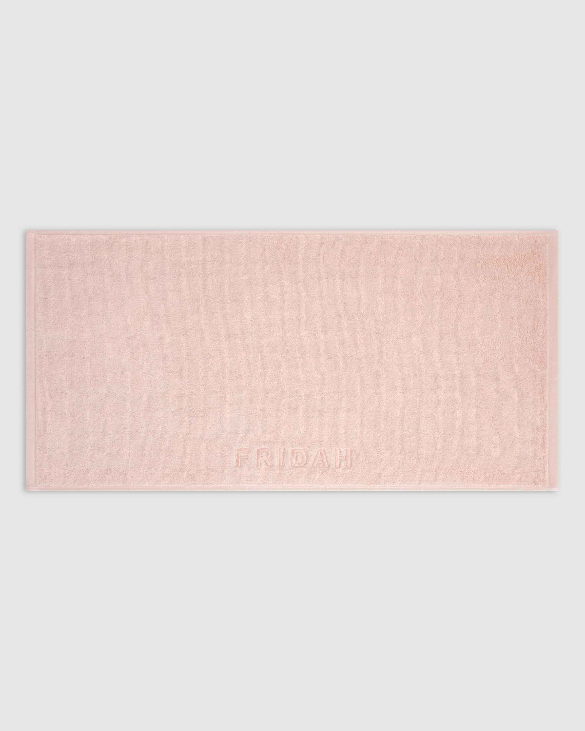 The Barrier Towel laid flat showing the embossed logo