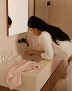 Blush | The Barrier Towel draped on a bench