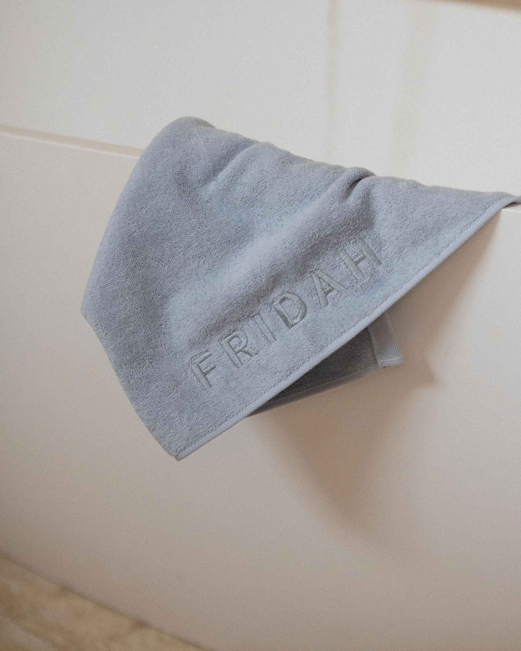The Barrier Towel folded over the bath