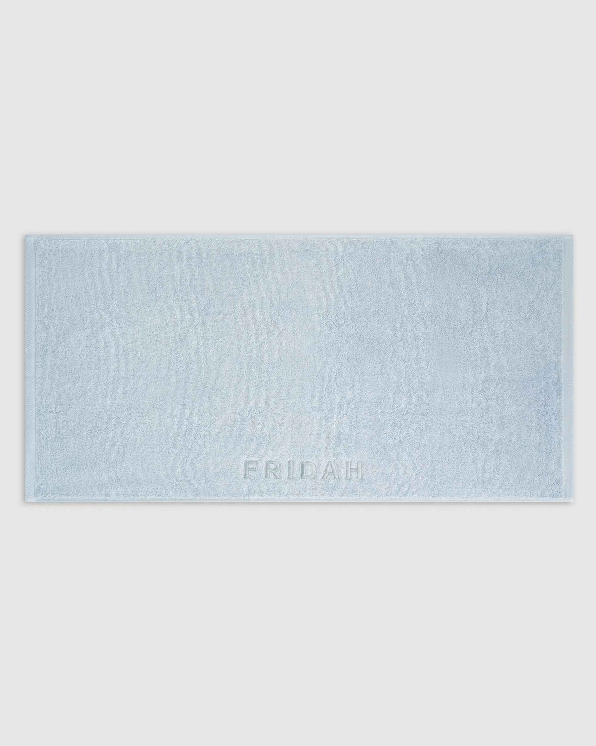 The Barrier Towel laid flat showing the embossed logo